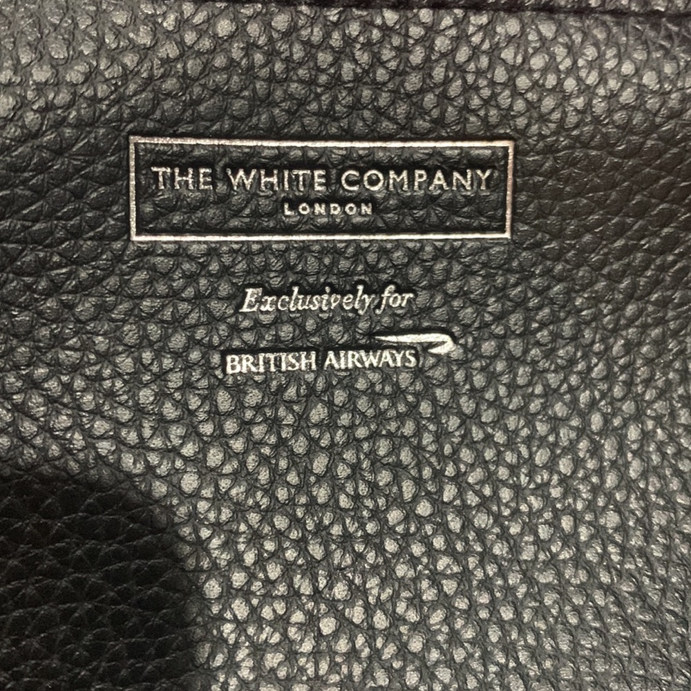 The white company London black cosmetics bag . New